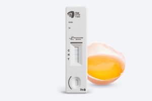 Egg Free Test lateral flow cassette showing result lines next to a raw egg for rapid allergen detection illustration.